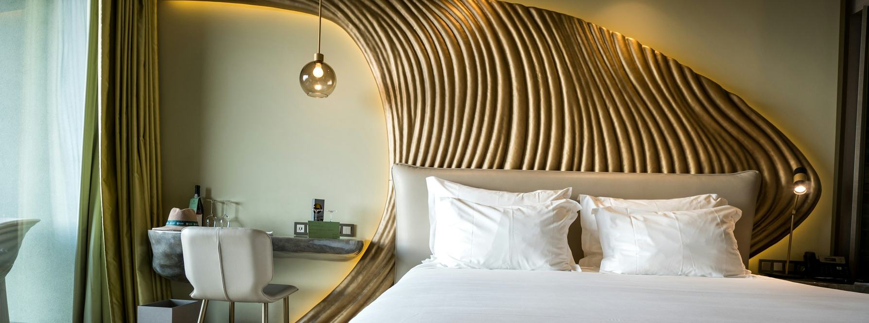 Hotel room with a sculpted wooden headboard